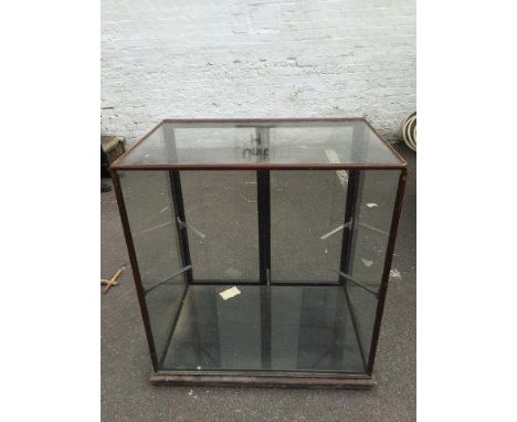 An Edwardian mahogany framed shop display counter with two rear opening doors and a glass shelf. 