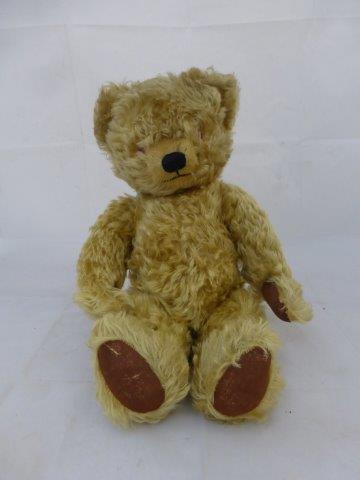 A Chad Valley jointed teddy bear with growler and side label, circa 1950s.