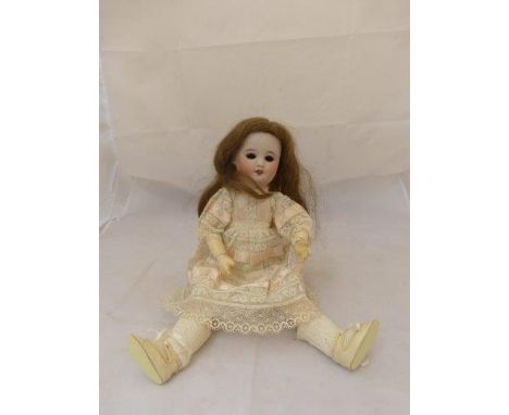 S.F.B.J Paris, an early 20th Century bisque headed doll with jointed arms, impressed mark, 15" tall.