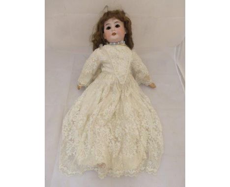An Armand Marseille bisque headed doll (eyes detached) with open mouth and teeth, composition jointed limbs and impressed mar