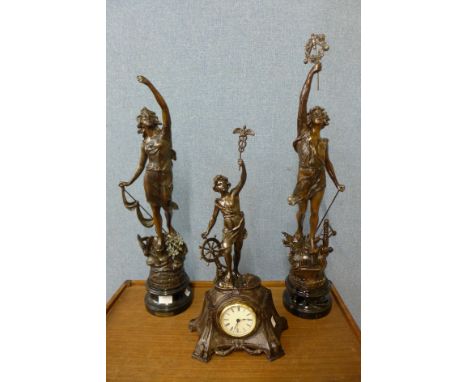 A pair of spelter figures and matching mantel clock 