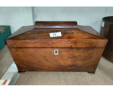 An early 19th century mahogany sarcophagus shaped tea caddy 