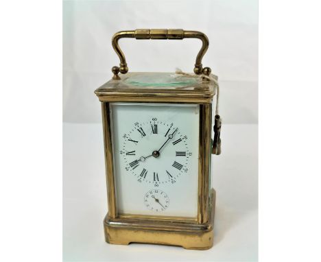 A late 19th/early 20th century brass carriage clock with white enamel dial and timepiece movement with alarm, height 15 cm 