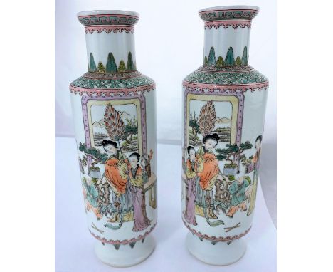 A pair of Chinese ceramic rouleau vases decorated with traditional family scenes, hand painted with characters to the back, h
