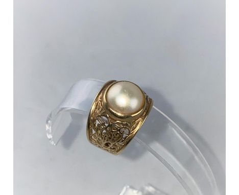 A large pearl set dress ring with extensively pierced shoulders, stamped '9ct', size R-S, 6.5 gm 