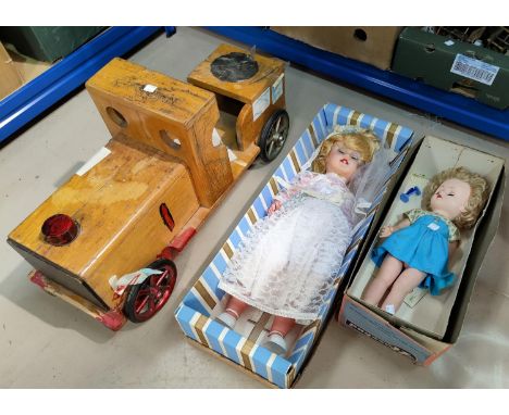 A ride-along toy engine and two 1960's dolls 
