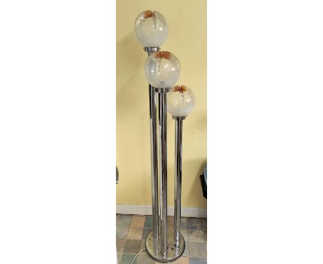 An Italian mid century chrome three height standard lamp in the manner of Mazzega with shaped glass light globes, on graduati