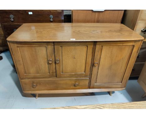 A 1960's Ercol elm sideboard with 3 cupboards and drawer.  Dimensions: Width 114cm; Depth 50cm; Height 81cmIn good condition 