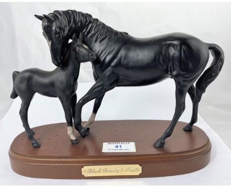 A Royal Doulton ceramic group Black Beauty and foal on wooden base 