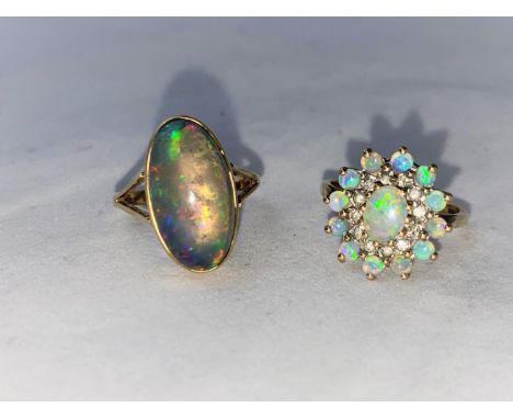 A 9 carat hallmarked gold dress ring set large oval opal coloured stone size 'O'; a 9 carat hallmarked gold ring set tiers of