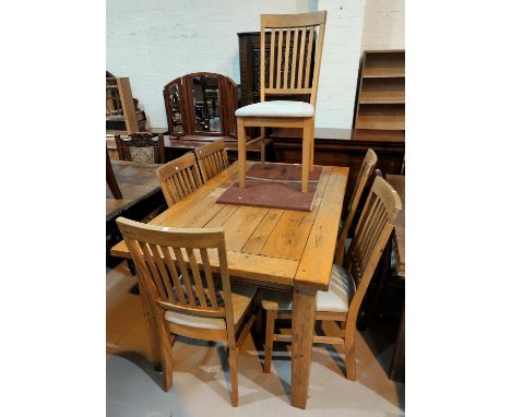 A modern light oak dining suite comprising extending table with rectangular top and 6 rail back chairs 