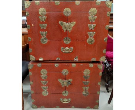 A pair of late 19th / early 20th century Chinese red lacquer cabinets with brass binding, with double doors to the front, but