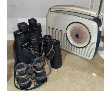 Three sets of binoculars and a vintage Bush radio 