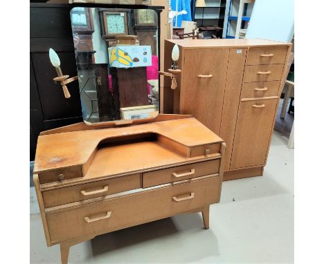 A 1950's light oak 2 piece bedroom suite comprising tallboy with hanging cupboard, small cupboard and 3 drawers, and 5 drawer