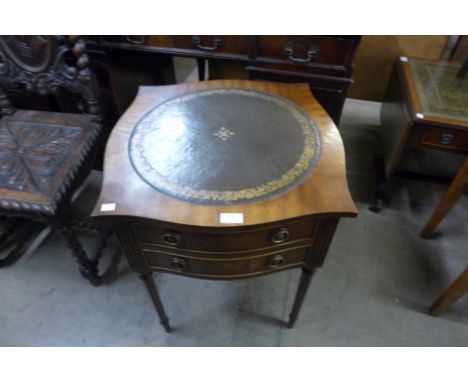A mahogany and green leather topped two drawer lamp table 