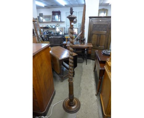 An early 20th Century carved oak barleytwist standard lamp 