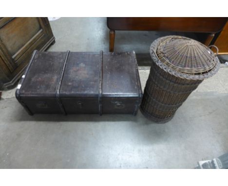 A banded steamer trunk and a wicker basket 