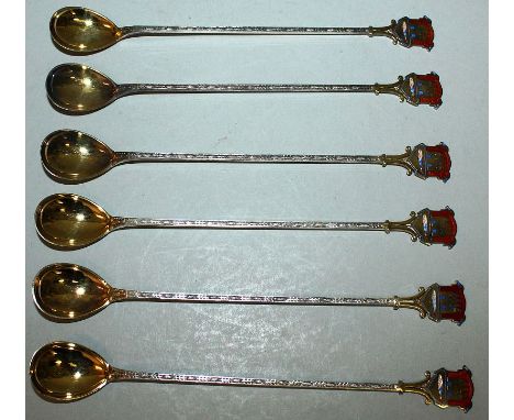 A SET OF SIX FINNISH SILVER GILT LONG HANDLED SPOONS, the handles with enamel coat of arms of OULU, FINLAND In original box, 