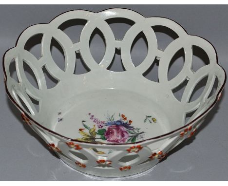 AN 18TH CENTURY WORCESTER PIERCED CIRCULAR BASKET painted with a central rose and other flowers and insects, applied flowers 