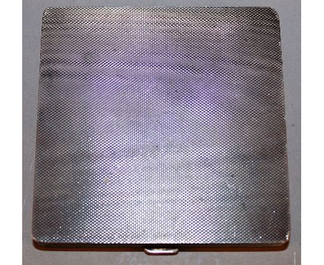 A HEAVY SQUARE ENGINE TURNED SILVER COMPACT.