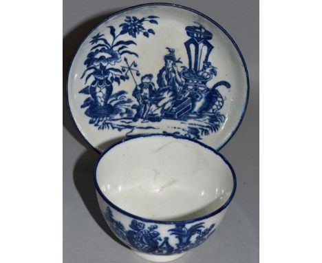 A WORCESTER BLUE AND WHITE TEA BOWL AND SAUCER “THE MOTHER AND CHILD”, CIRCA 1775-1785.