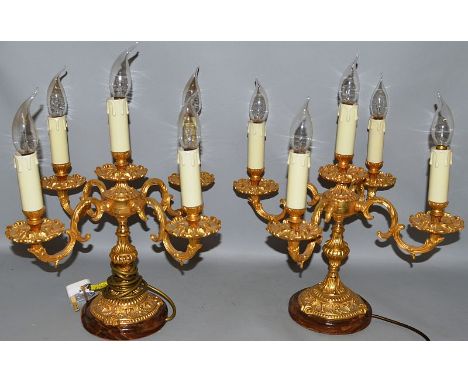 A PAIR OF LOUIS XVI DESIGN ORMOLU FIVE LIGHT CANDELABRA, each with four candle branches on circular bases converted to electr