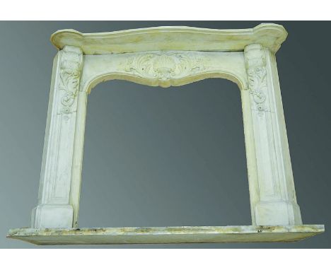  A SUPERB 19TH CENTURY WHITE MARBLE FIREPLACE with mantelpiece of serpentine outline, the frieze with well carved shell and f