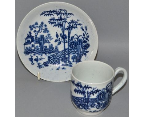 AN EARLY WORCESTER COFFEE CUP AND SAUCER decorated with huts, geese, fence and bamboo (33).