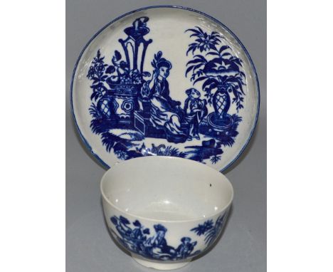 A WORCESTER TEA BOWL AND SAUCER decorated with a woman, child and Oriental furniture, crescent mark (50).