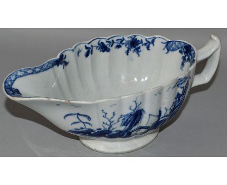 A WORCESTER SAUCEBOAT OF FLUTED FORM decorated with a fisherman on an island beside a bridge, the reverse with a boat and isl