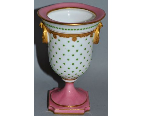 A SMALL ROYAL WORCESTER URN SHAPED VASE, gilt edges, handles and beadwork with a small painted panel, Pattern No 2328 4.25ins