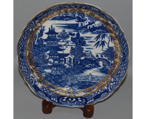 A CAUGHLEY TEA CANISTER AND COVER decorated with a Chinese scene in under-glaze blue, a similar saucer dish and a coffee cup.