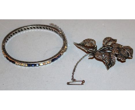 A MARCASITE BROOCH AND A SILVER PASTE BANGLE.