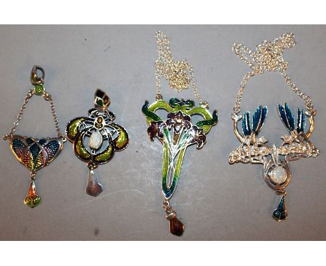 FOUR ART DECO SILVER AND ENAMEL PENDANTS.