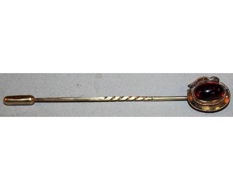 A 9CT GOLD AND CABOCHON STICK PIN.