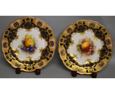 A PAIR OF ROYAL WORCESTER PLATES painted by Sebright under a blue and gilt border.