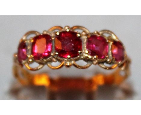 A VICTORIAN 15CT GOLD FIVE STONE RUBY RING.