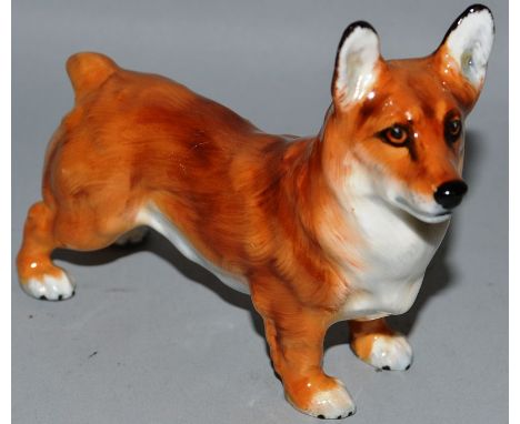 A ROYAL DOULTON MODEL OF A STANDING CORGI.