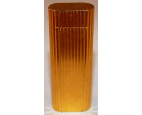 A CARTIER GOLD COLOURED RIBBED LIGHTER, No 27896