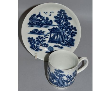 AN EARLY WORCESTER COFFEE CUP AND SAUCER painted with two islands both with pagodas, workman’s mark to saucer (31).