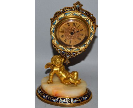 A GOOD SMALL 19TH CENTURY FRENCH BRASS, ONYX AND CHAMPLEVE ENAMEL CLOCK with watch movement held aloft by a winged cupid on a
