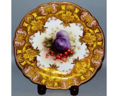 A FINE ROYAL WORCESTER PLATE painted with fruit on a yellow highly gilt ground by Richard Sebright.
