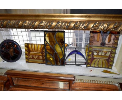 Four stained and leaded glass panels; together with another stained glass panel. 