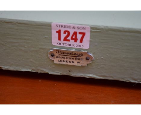 A large vintage doll's house, labelled Hamley's, 143cm wide. 