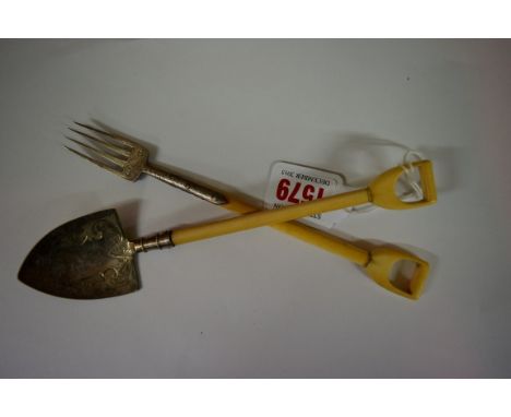 A Victorian novelty miniature ivory and electroplate mounted mounted garden fork and spade set, 19.5cm long. 