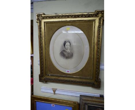 A pair of antique gilt wood and gilt gesso frames, rebate 46.5 x 40.5cm, each enclosing a photographic portrait.