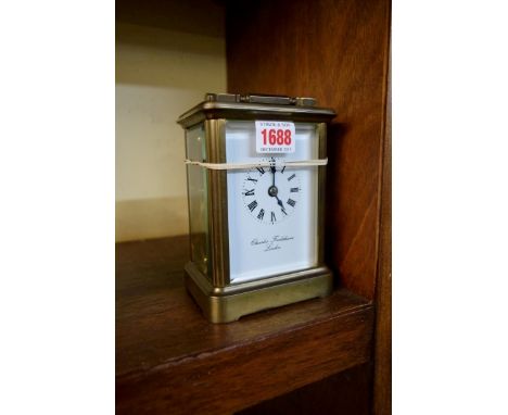 A large brass carriage clock, the enamel dial inscribed 'Charles Frodsham, London', with bell striking movement, height inclu