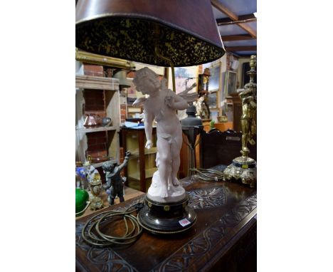 A pottery figural cherub table lamp, with leather shade, total height, 81cm; together with another brass figural table lamp. 