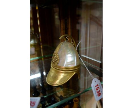 A shell and gilt brass novelty helmet form watch stand, 10cm high, (cracks). 