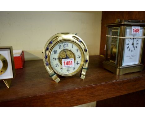An Edwardian brass and enamel novelty horseshoe timepiece, 12cm high. 